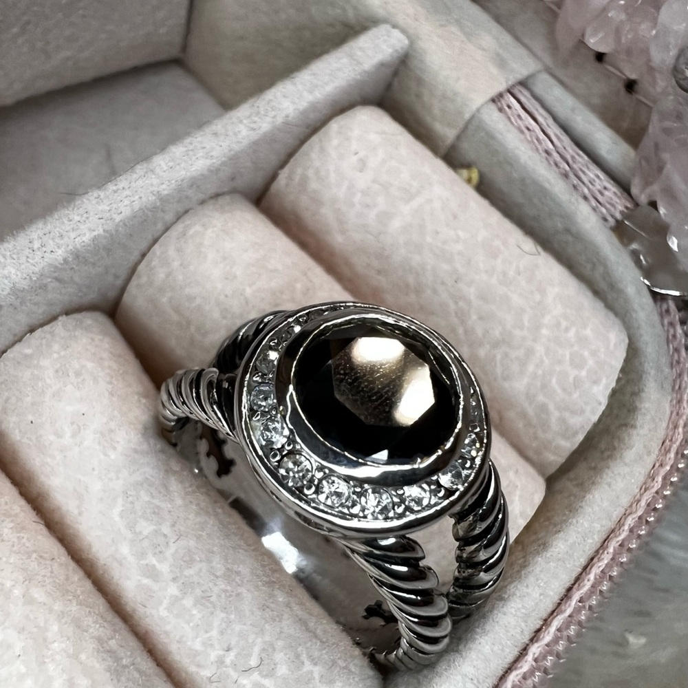 Fashion jewelry “silver” ring with black stone.